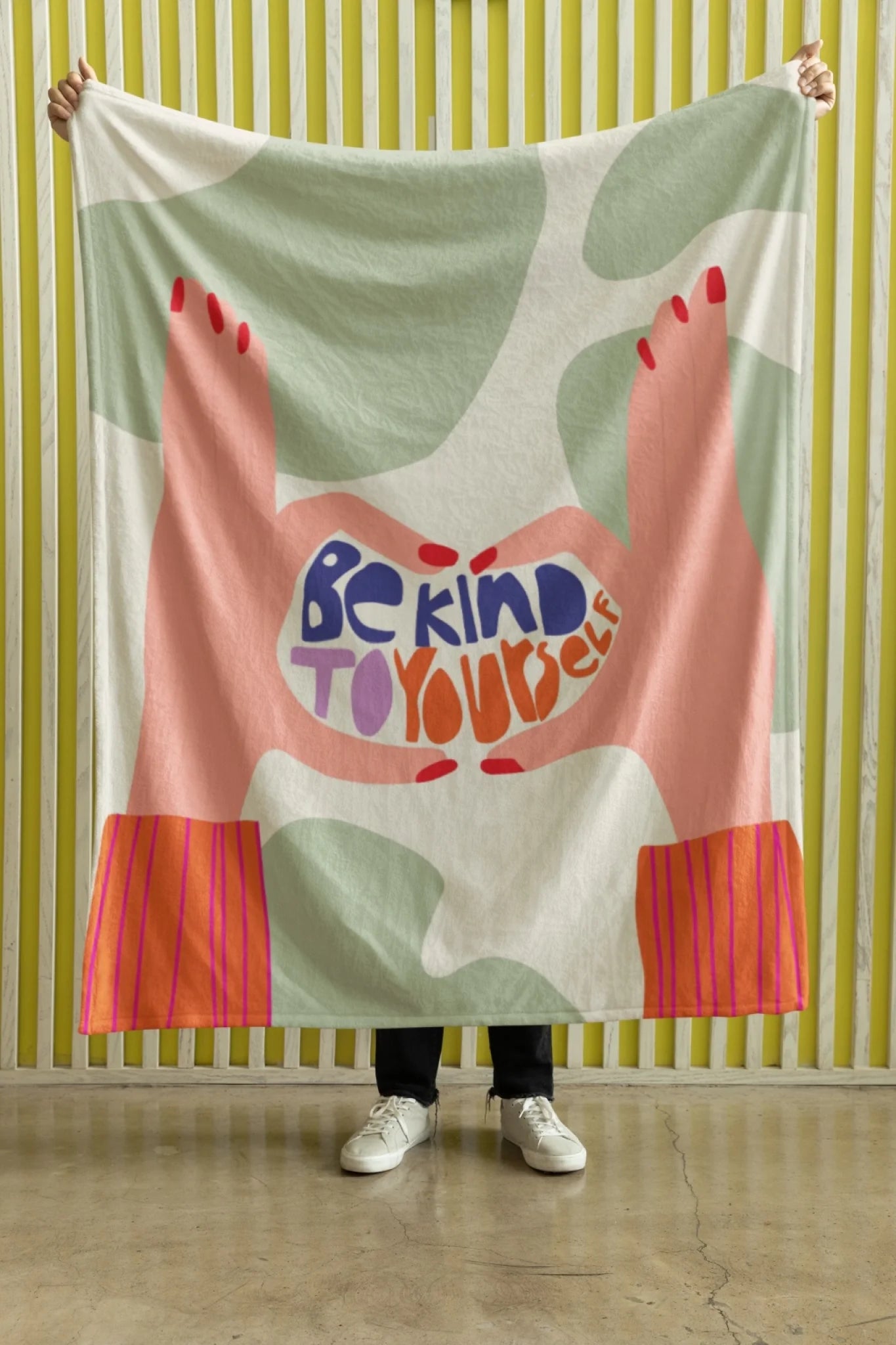 mockup-of-a-person-holding-a-velveteen-plush-fleece-blanket-against-a-yellow-wall-m35704